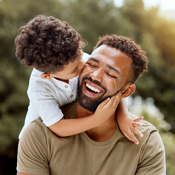 boy kissing dad's cheek